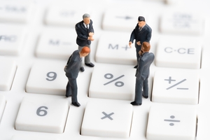 Businessmen on Calculator