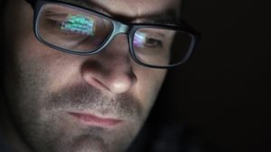man gambling reflection in glasses