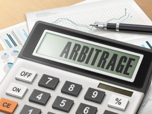 calculator with arbitrage written on it