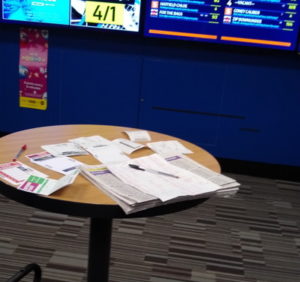 betting slips and newpaper on table in bookmaker shop