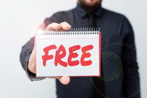 man holding notepad with word free written on