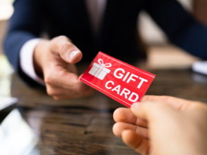handing someone a gift card voucher